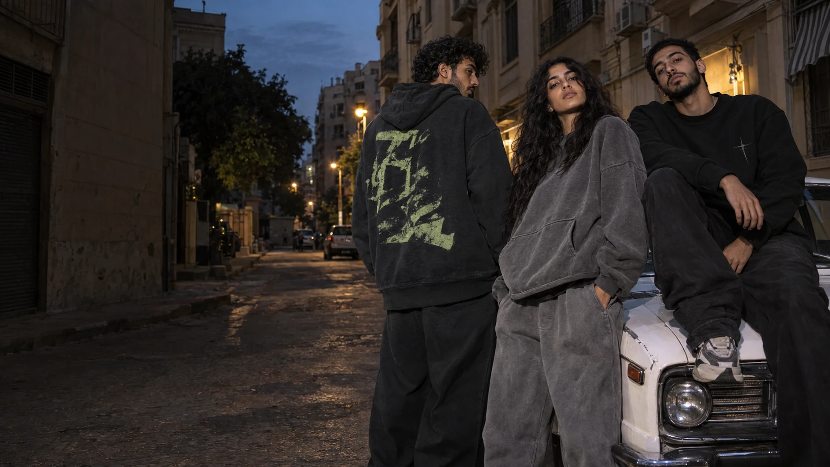 Campaign concept: three friends in oversized streetwear on a Cairo street at dusk